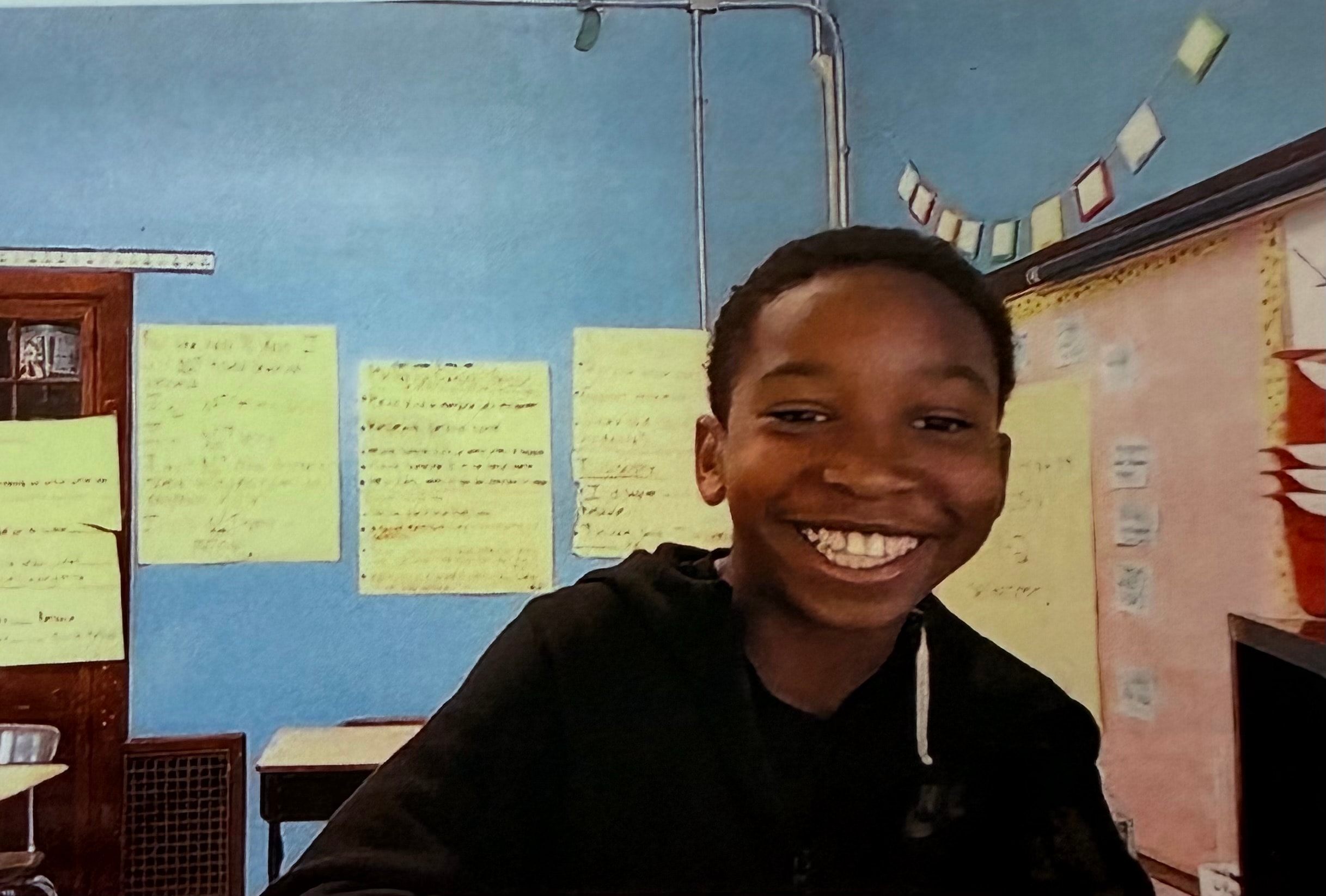 Logan Scott smiling in a classroom setting